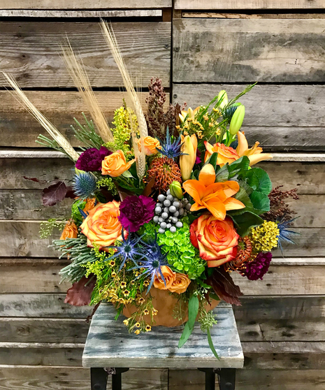 fall toned flowers in pumpkin vase