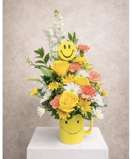 Be Happy with Roses - Yellow roses, white and yellow daisies fill a bright smiley face yellow mug. 