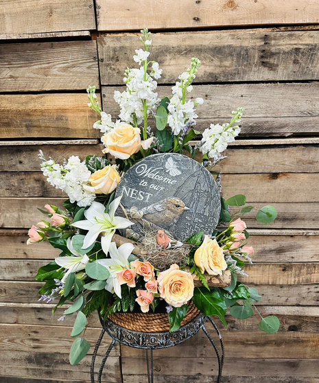 cream and white floral arrangement with gardens stone