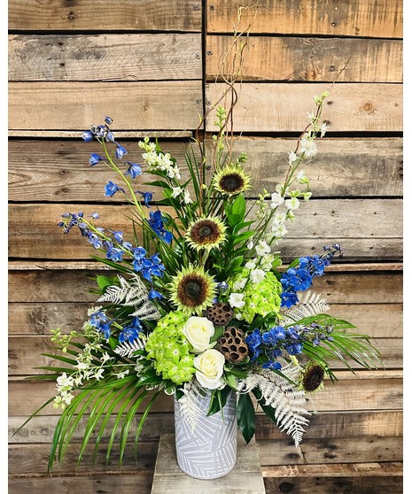 a keepsake bamboo leaf embellished vase including delphiniums, hydrangea, roses, and larkspur