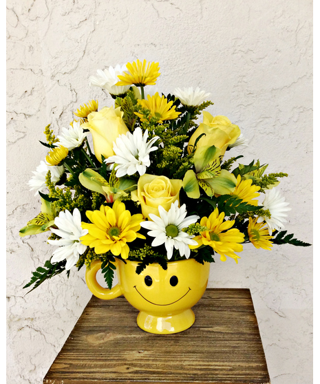 Be Happy with Roses - Yellow roses, white and yellow daisies fill a bright smiley face yellow mug. 