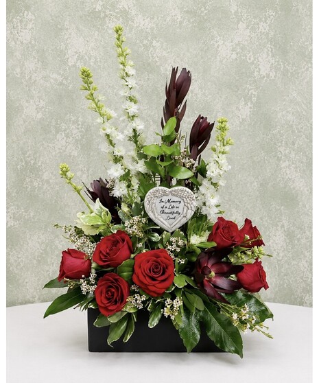 sympathy arrangement with roses, lilies, and so much more