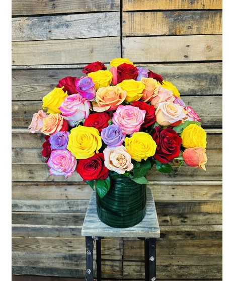 colorful roses in out-sized leaf lined vase