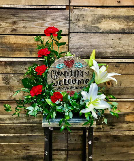 happy keepsake sign accented with red roses and lilies