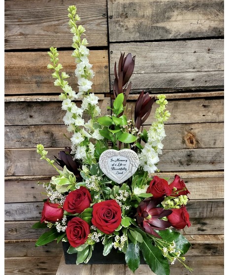 sympathy arrangement with roses, lilies, and so much more