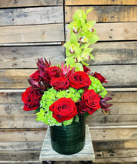 red roses and green hydrangeas accented with safari sunset
