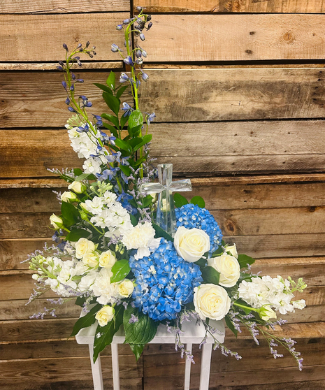 blue and white sympathy arrangement with small crystal cross