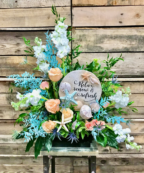 relax and renew aqua and peach floral arrangement with keepsake garden stone