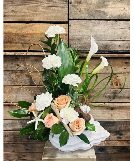 long lasting white carnations, peach roses and lush foliage