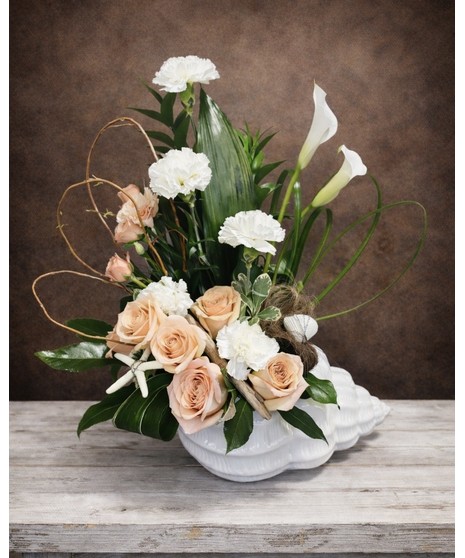 long lasting white carnations, peach roses and lush foliage