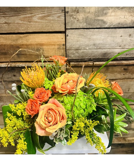  Gorgeous orange pincushion protea, cherry brandy roses, orange spray colors and vivid green hydrangeas