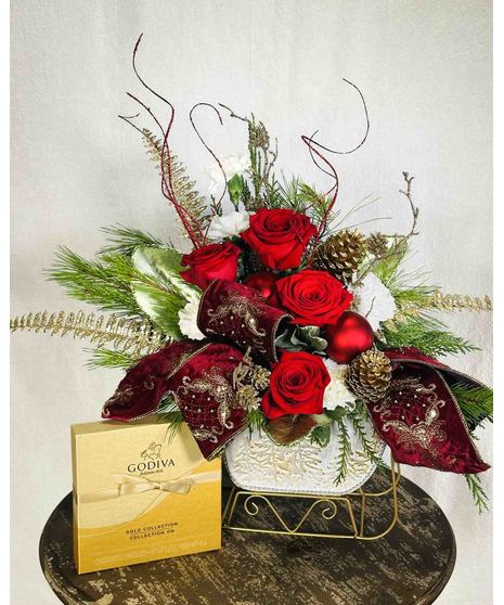 holiday floral arrangement in sleigh shaped container