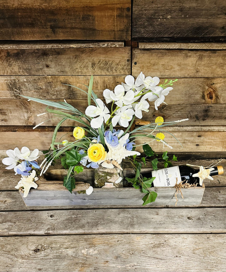 rustic box with silk flowers, wine, and sea side accents