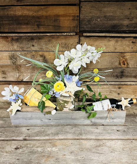 rustic box with silk flowers, wine, and sea side accents