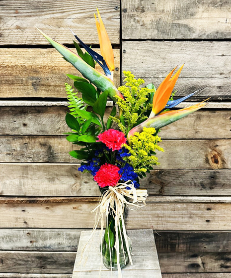 bright tropical bud vase filled with flowers