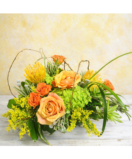  Gorgeous orange pincushion protea, cherry brandy roses, orange spray colors and vivid green hydrangeas