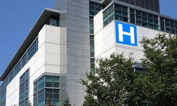 A multi-story building displays a large blue 